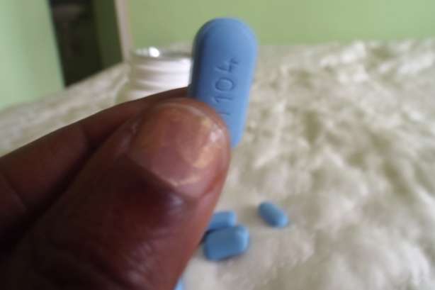 Hand holding antiretroviral pill