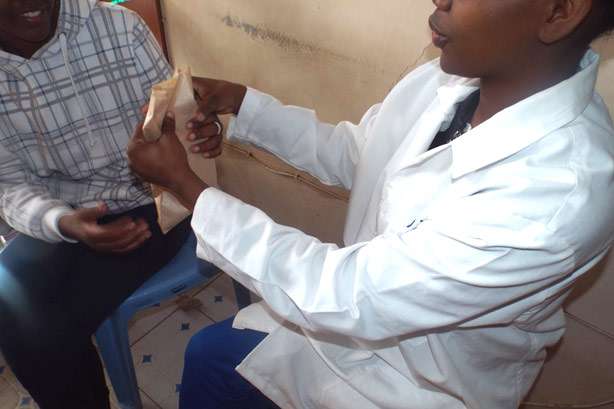 Dennis visiting a health worker